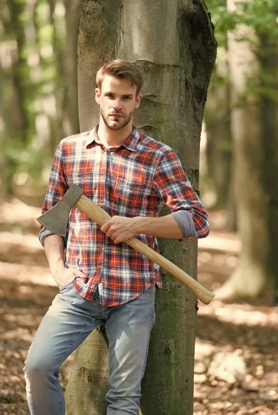 Leñador de pie en el bosque con hacha, verano — Foto de Stock