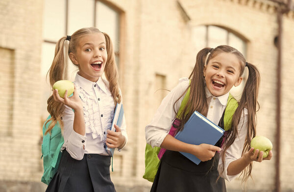 Cheerful schoolgirls enjoying healthy school lunch, knowledge day concept