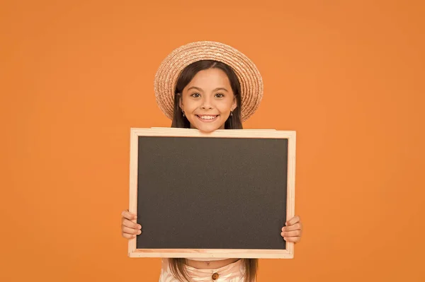 Día del conocimiento. Niña pequeña y feliz mantener el tablero. publicidad y marketing. calendario de campamento infantil para la actividad de verano. moda de verano adolescente chica. viajar a un país cálido. ventas de compras de verano. espacio de copia — Foto de Stock