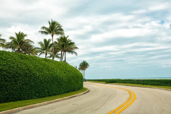 Seaside highway along bush fence on cloudy outdoors in Palm Beach Florida, USA, road bend — Foto Stock