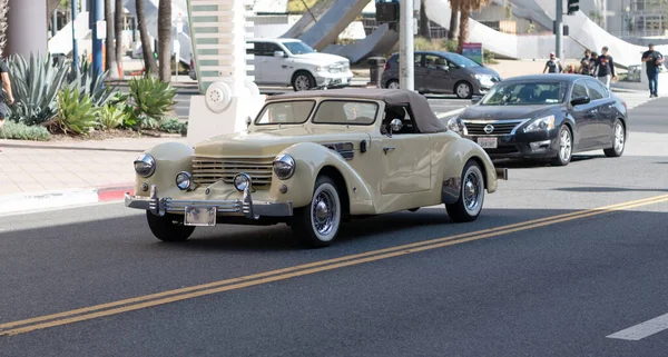 Long Beach, California USA - April 12, 2021: antique light beige retro car cabriolet side view. — Stock Fotó