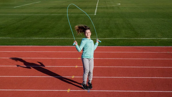 Rope skipping. Energetic child jump over skipping rope. Gymnastics. Fitness and sport — Stockfoto
