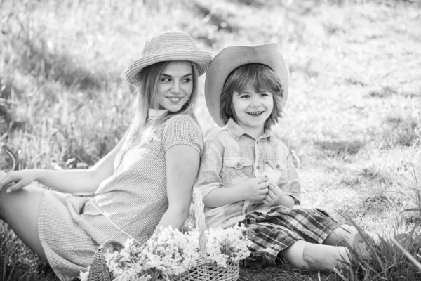 Spring holiday. Good vibes. Spring season. Happy holidays. Cowboy family collecting spring flowers. Eco living. Love and respect motherland. Weekend leisure. Explore nature. Mother and son relaxing
