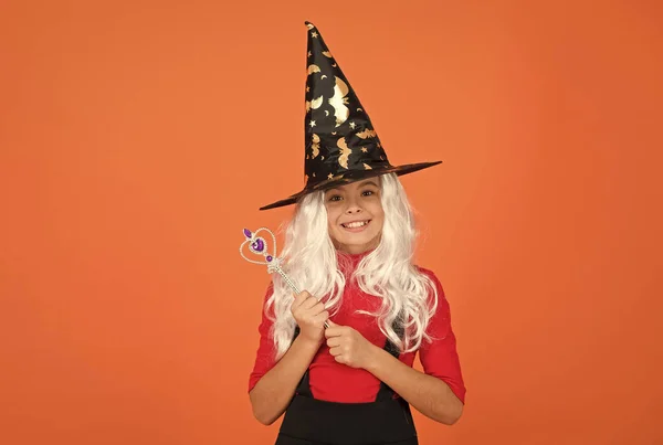 Witching with love. work wonders. carnival costume party. trick or treat. celebrate the holidays. childhood happiness. happy halloween witch girl. child in witch hat. cheerful kid use magic wand