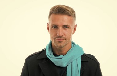 Olgun, tıraşsız bir adam eşarp takar. Erkek güz mevsimi modası. Beyaz arka planda izole edilmiş yakışıklı bir adam. Erkek saçı güzellik ve bakım. Berber salonu. yüz bakımı konsepti