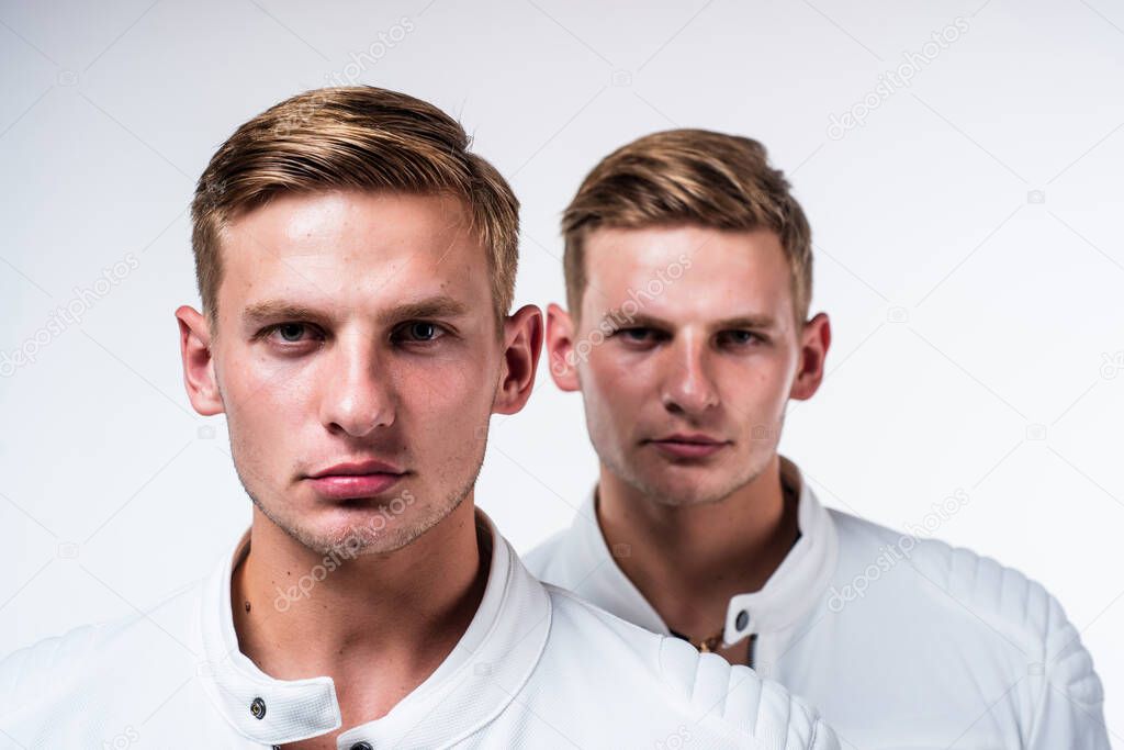twin brothers men in white casual clothes look alike, brother