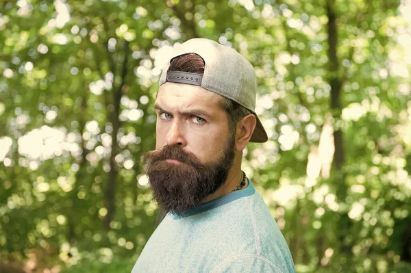 Hombre barbudo maduro con gorra. vacaciones de campamento de verano. hombre hipster senderismo. cuidado de la barba masculina. brutal hipster en el bosque. descubrir nuevos lugares. Hora del picnic. caucásico chico con bigote — Foto de Stock