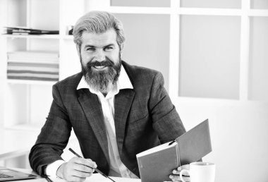 İş çözümleri. Riskli bir iş. Sakallı patron dizüstü bilgisayarla oturuyor. Yönetici sorunları çözüyor. Entelektüel bir görev. Finansal analiz. Standartları yükseltmek. Borsa. Ofis personeli konsepti