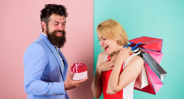 Everything she wants. Man bearded hipster hold gift box and girl enjoy shopping. Ask man to purchase lots presents for girlfriend. Couple with luxury bags in shopping mall. Couple enjoy shopping — Stock Photo, Image