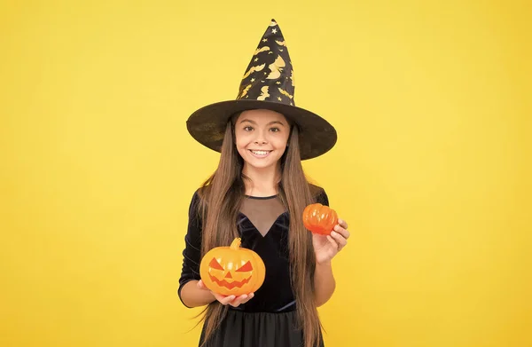 halloween kid in witch hat hold pumpkin jack o lantern for witchcraft, halloween pumpkin