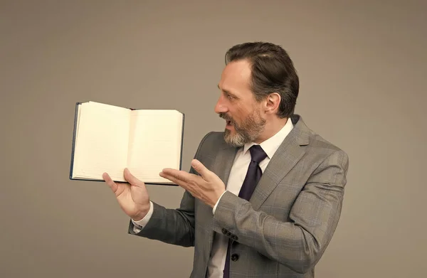 Hombre barbudo sorprendido en traje formal de negocios mostrar libro abierto para información, espacio de copia — Foto de Stock