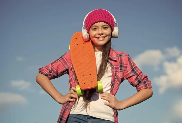 Active lifestyle. Active girl skater hold penny board sunny sky. Action sport. Recreational activity. Healthy life. Skateboarding and transportation. Summer vacation. Outdoor adventure