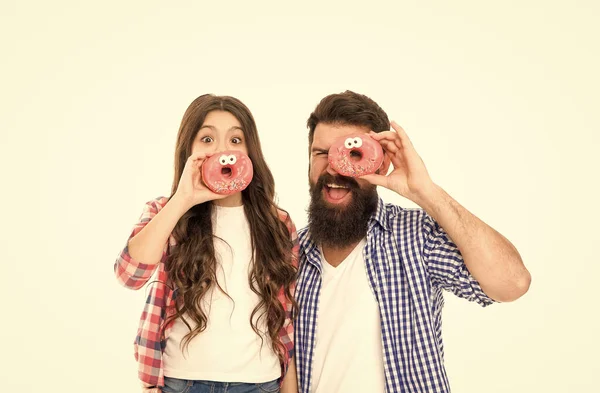 Vrolijke familie. Mooie bui. Bakkerij winkel. Vaderdag. Zoetekauw. Meisje, kind en vader hebben glazen donuts. Snoep en lekkernijen concept. Dochter en vader eten zoete donuts. Het dessert. Geluk en vreugde — Stockfoto