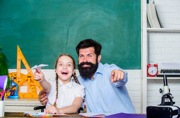 we are the team. daughter study with father. Teachers day. knowledge day. Home schooling. private lesson. small girl child with bearded teacher man in classroom. back to school. Private teaching