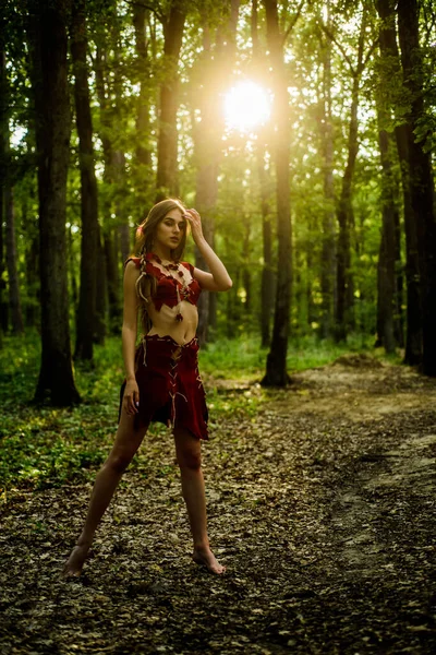 Sexy legs. amazon woman. sexy witch. cougar female. wild woman in forest. sexy girl in leather suede clothes. ethnic tribal fashion. deep forest. female silhouette through the sun rays — Stock Photo, Image