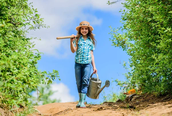 Spring gardening checklist. Little helper. Watering tools that will solve dry yard problems. Removable rose allows moderate flow. Gardening tips. Spring gardening. Girl child hold shovel watering can — Stock Photo, Image