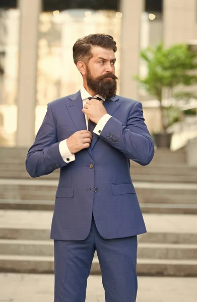 Σοβαρός σκηνοθέτης με γενειάδα hipster καθορίσει γραβάτα φορώντας επίσημο κοστούμι σε εξωτερικούς χώρους, φορμαρισμένο ένδυμα — Φωτογραφία Αρχείου