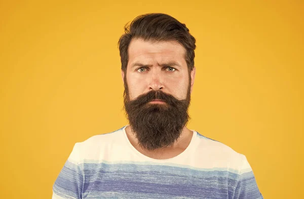 Bend his brows. serious stylish man with moustache. thinking brutal bearded man on yellow background. handsome confident man has perfect hairstyle. male facial care. portrait of brutal bearded man — Stock Photo, Image