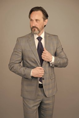 Yakışıklı, olgun bir çalışan resmi takım elbise giyer, şık bir görünüm sağlar.