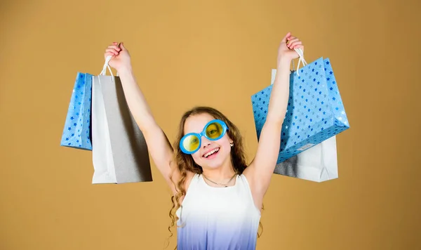 Black friday. Sale discount. Shopping day. Child fashion girl sunglasses hold package. Favorite kids brand. Girl with shopping bag. Shopping tour abroad. Summer season sale. Shopping and purchase — Stock Photo, Image