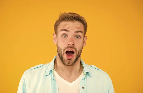 Surprised guy with unshaven face. expressing human emotions. bearded sexy man wearing casual shirt. male spring fashion style. mens facial care and beauty. having trendy haircut — Stock Photo, Image