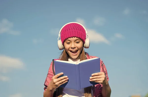 Get high on sound quality. Happy kid listen to audio book blue sky. Audio technology. Audio courses. English school. Learning foreign language. Modern life. Music education