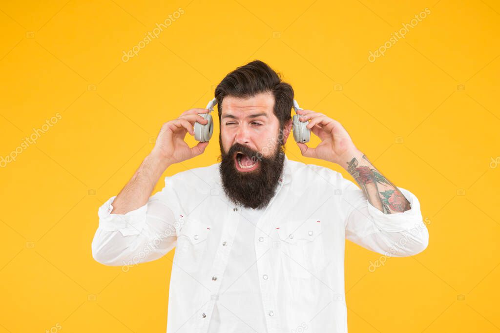 Hearing problem. Bearded man headphones. Active Noise Cancellation Technology. Hipster listen music stereo headphones. Modern wireless headphones. Dance music tracks. Ears health. Loud music