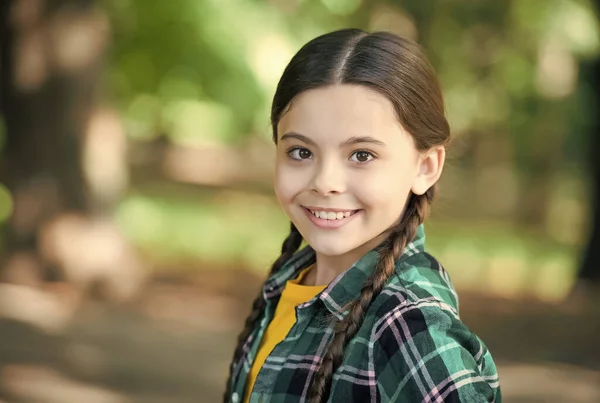 Niña scout lindas trenzas desgaste a cuadros ropa naturaleza fondo, concepto de pensamiento positivo —  Fotos de Stock