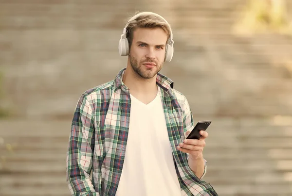 Busy man wireless headphones use smartphone, download application concept
