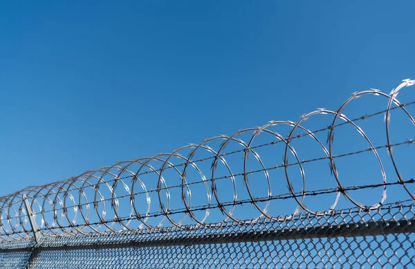 barbwire perimeter fence. ensuring safety and security. jail wall.