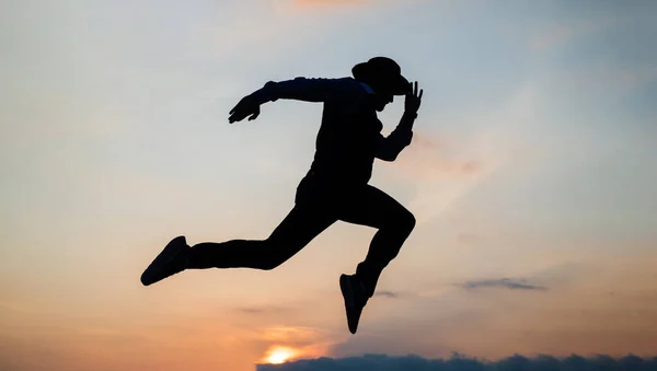 日の出の空を自由に走る男のシルエットスタミナ — ストック写真