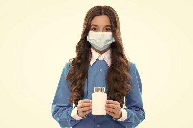 Coronavirus covid-19 salgını ve virüsün yayılmasını önlemek için ilaç kavanozuyla solunum maskesi takan çocuk.