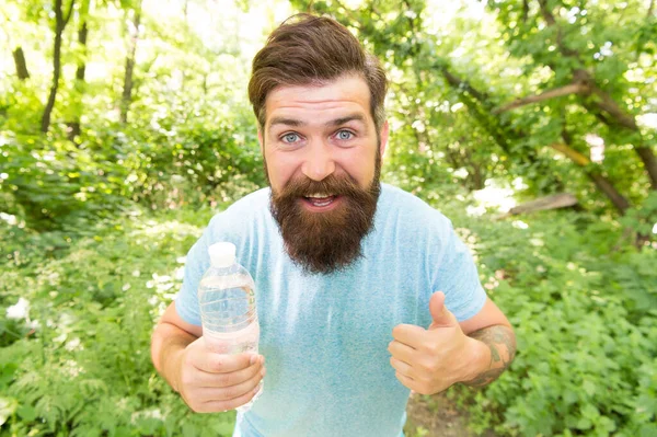 Guy maintains body water balance. hydration. daily water. cheerful bearded man hold bottle — ストック写真