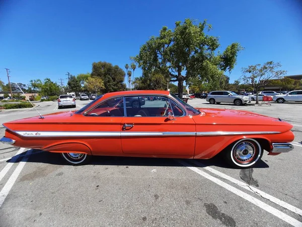 Los Angeles, California USA - March 28, 2021: red chevrolet impala retro car side view — Stock Photo, Image