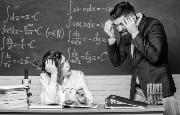 Problem solving. Bearded man and sexy woman consider problem at lesson. Problem at school. Educational problem. Finding solution. Communication skills