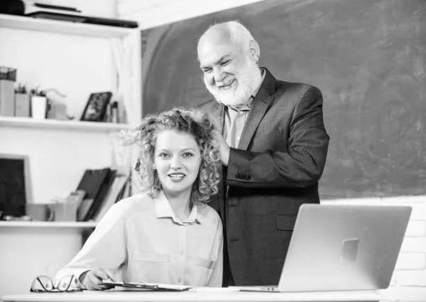 Tarea. estudiar a través del sistema de aprendizaje electrónico en línea. aprobar el examen. sala de profesores. chica estudiante feliz con tutor hombre en pizarra. estudiante y tutor con laptop. profesora y mujer sénior en la clase escolar — Foto de Stock