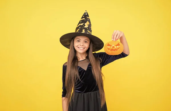 Celebrate the holidays. jack o lantern. halloween witch girl. happy childhood. teenage child in witch hat. cheerful kid holding pumpkin. carnival costume party. trick or treat. Monster of a Sale — Stock Photo, Image