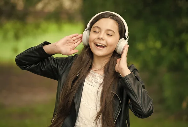 Hipster dziewczyna słuchanie muzyki nowoczesne słuchawki natura tło, śpiew koncept hobby — Zdjęcie stockowe