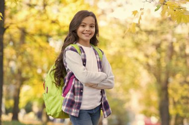 Rahatlama zamanı. Sonbahar çocuk modası. İlham için romantik bir sezon. Mutlu çocukluk. Okula dönüyorum. Sırt çantalı genç kız parkta yürürken rahatlıyor. Sonbahar güzeli. Ormanda günün tadını çıkar.