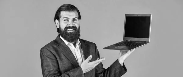 high quality notebook. go shopping online. confident businessman with laptop. brutal male with beard in suit. handsome ceo hold computer. boss and employee. agile business. online education concept