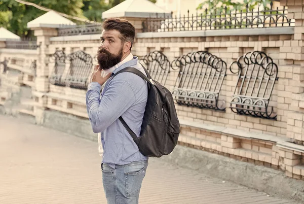 Vacation concept. Backpack for urban traveling. Hipster backpack urban street background. Bearded man travel. Guy exploring city. Tourism and backpacking. Modern rest. Discover local showplace — Stock Photo, Image