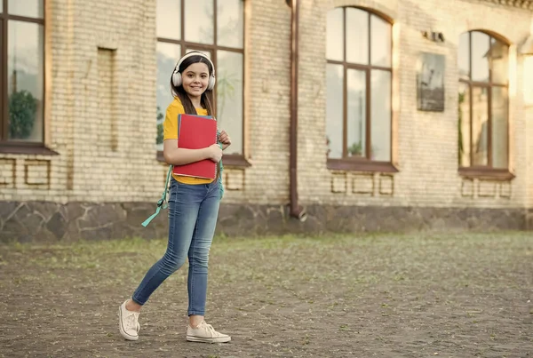 Učit se je zábavnější. Dítě nosí sluchátka venku. Moderní technologie ve vzdělávání. Vzdálená škola. Kurzy cizích jazyků. Naslouchací schopnosti. Moderní životní styl, kopírovací prostor — Stock fotografie