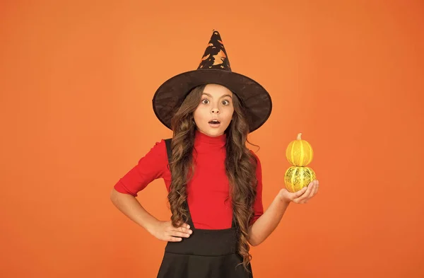 Surprised girl in witch hat costume to halloween with small yellow pumpkin, happy halloween party — Stock Photo, Image