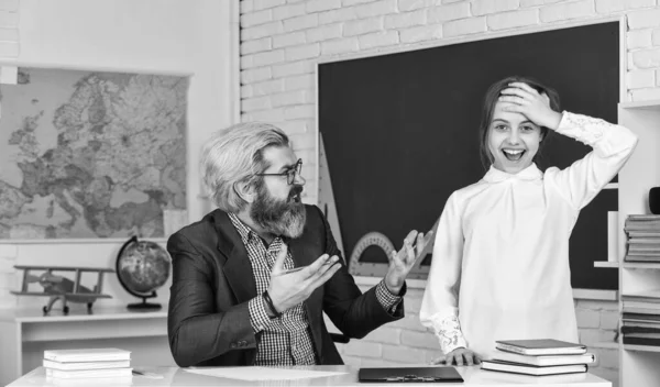 Chica caprichosa. profesor y colegiala en la lección. de vuelta a la escuela. Niña y hombre contra pizarra. concepto del día del conocimiento. niño con maestro en el aula en la escuela. feliz día de los maestros —  Fotos de Stock