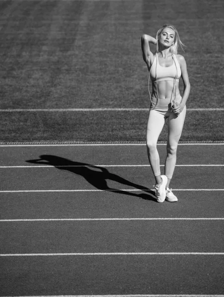 Sexy fitness kobieta trzymać skakanka w odzież sportowa na stadionie, aktywny dzień — Zdjęcie stockowe