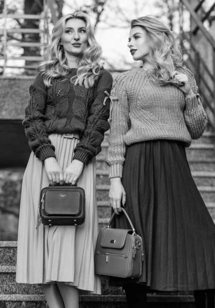 Matching colors. Personal stylist service. Sweater skirt trend. Completing each other. Vogue concept. Girls blonde wear matching clothes. Matching outfits. Women sisters outdoors stairs background — Stock Photo, Image