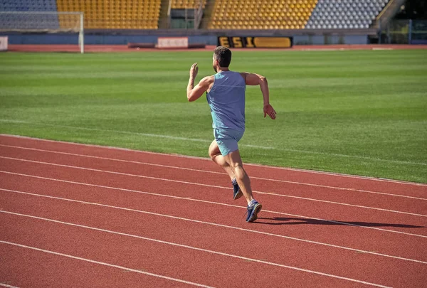 Aim and success. man running on stadium. sports and healthy lifestyle routine. sport workout. athlete do morning exercise. sportsman runner outdoor. health care. energy. muscular guy run to success — Stock Photo, Image