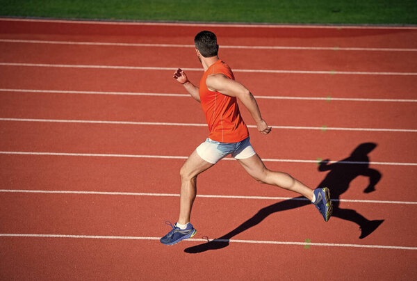 sportsman guy in sportswear run fast sprinting on running track, stamina