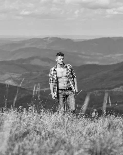 Sexy e bello. avventura itinerante. moda hipster. concetto di campagna. contadino su rancho. cowboy all'aperto. sexy macho uomo in camicia a scacchi. uomo sul paesaggio montano. campeggio ed escursioni — Foto Stock