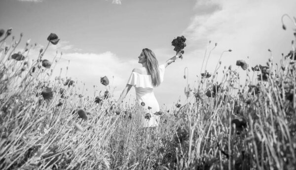 Young beautiful woman in spring walking in amazing poppy field, freedom.. Black and white.